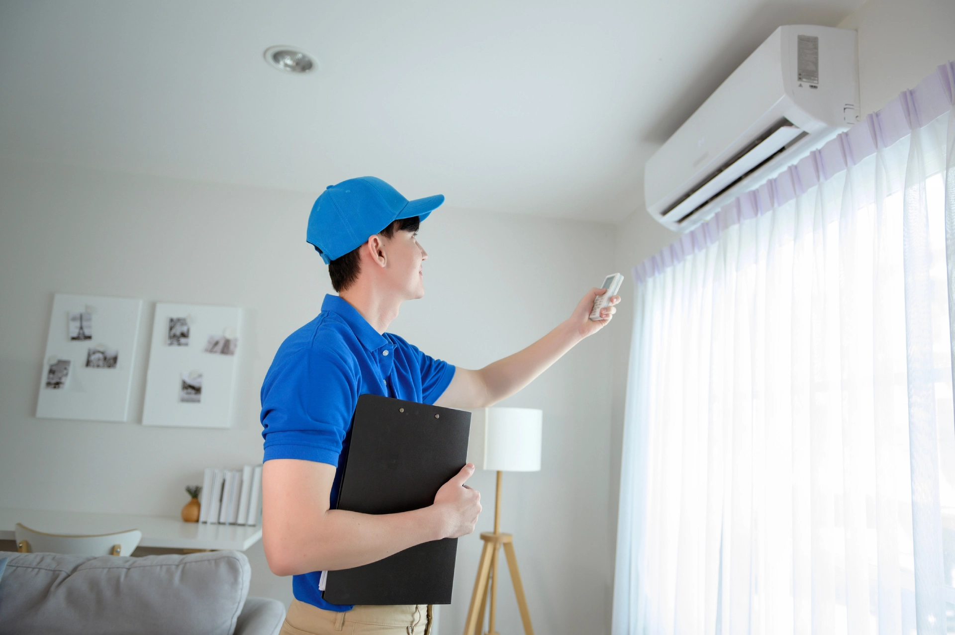 An-Asian-young-Technician-service-man-wearing-blue-uniform-checking